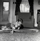 Boy playing with a toy car on the floor poster print