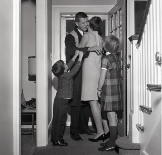Kids Welcoming Father Home Poster Print depicting a heartwarming family scene.