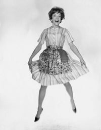 Portrait of a young woman laughing and jumping poster print