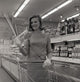 Young woman shopping in supermarket poster print