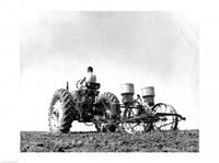 Farmer planting corn with tractor in a field poster print.