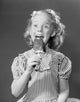 Studio portrait of a girl enjoying a popsicle, colorful and vibrant.