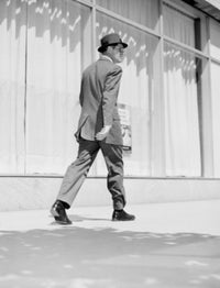 Poster print of a rear view of a businessman walking in downtown