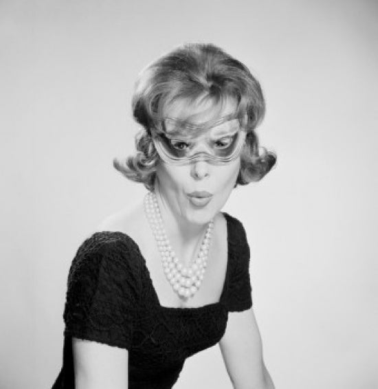 Portrait of attractive young woman wearing a carnival mask.