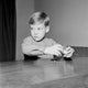 Young boy putting coins in piggy bank poster print