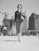 Cheerful businesswoman carrying shopping bags poster print