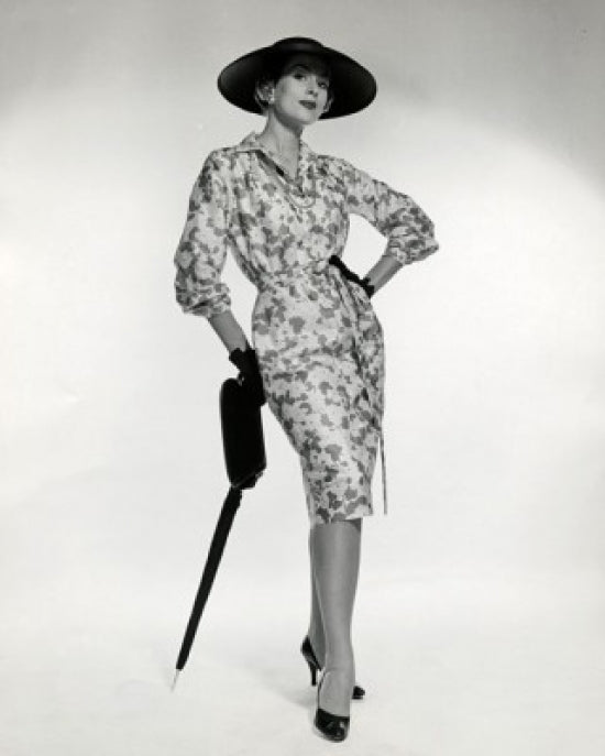 Portrait of elegant young woman leaning on an umbrella poster print