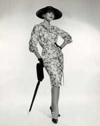 Portrait of elegant young woman leaning on an umbrella poster print