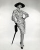 Portrait of elegant young woman leaning on an umbrella poster print