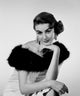 Studio portrait of young woman in elegant clothes poster print.