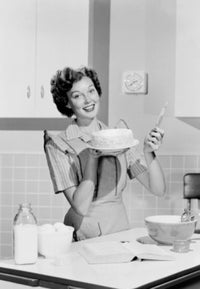Young woman preparing cake in a domestic kitchen poster print