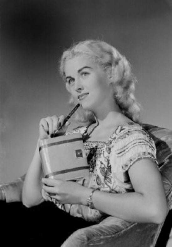 Young woman sitting in a chair holding a personal organizer poster print