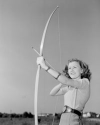 Young woman shooting with a bow poster print