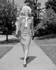 Young elegant woman walking down the street poster print