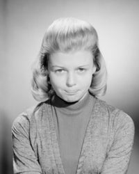 Studio portrait of a young woman pouting, expressive art print.