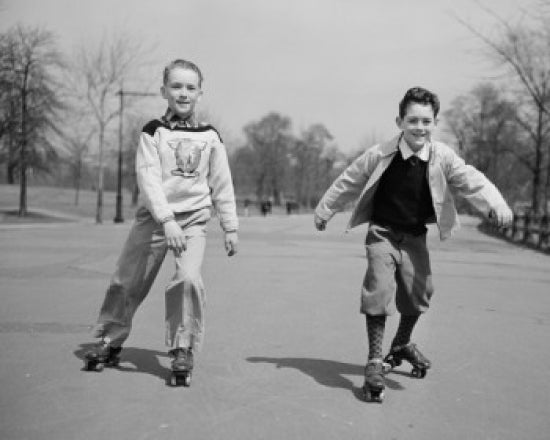 Poster print of two boys roller skating in a park.