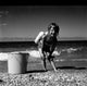 Girl Playing on Beach Poster Print showcasing a child enjoying the beach.