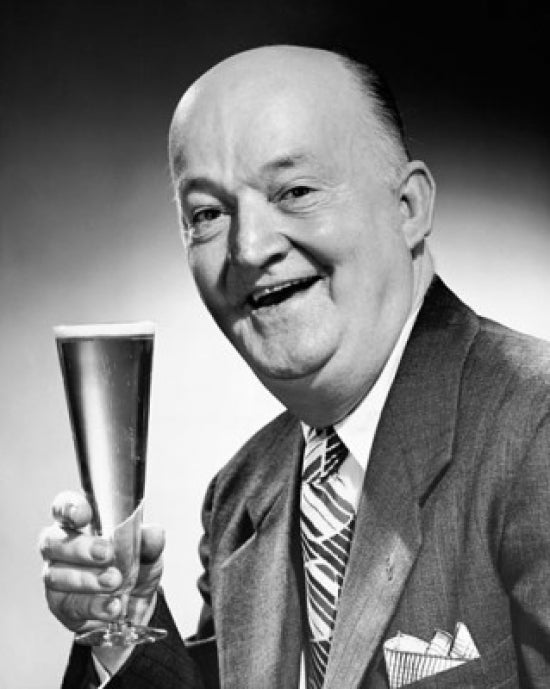 Portrait of a senior man holding a glass of beer poster print
