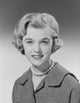 Studio portrait of a young woman smiling, vibrant colors and joyful expression.