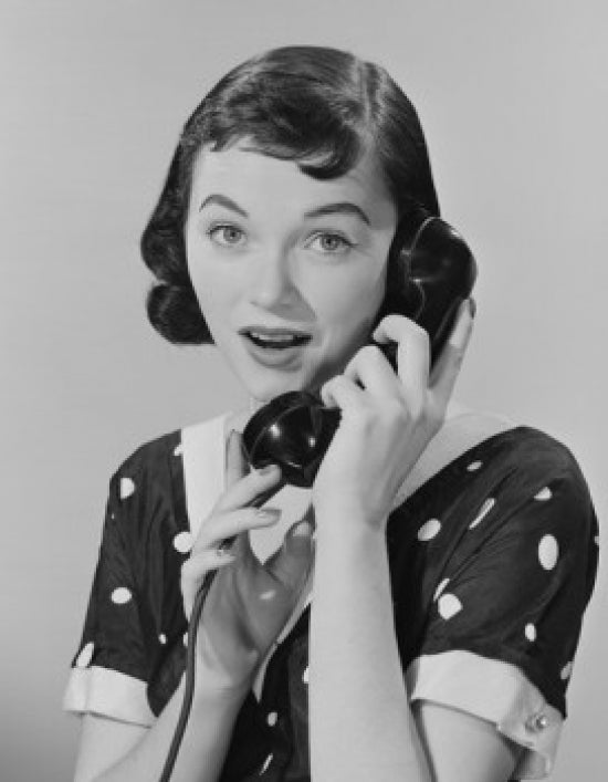 Studio portrait of a young woman talking on the phone, poster print.