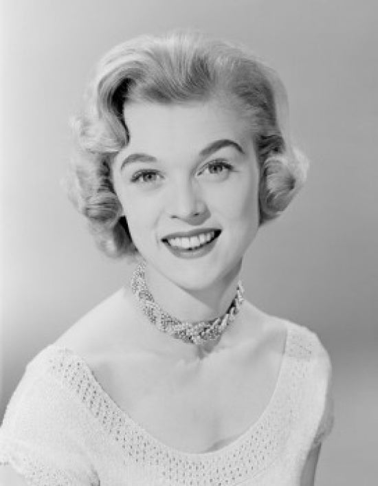 Studio portrait of a smiling young woman poster print.