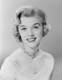 Studio portrait of a smiling young woman poster print.