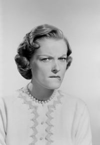 Studio portrait of a mid adult woman frowning poster print
