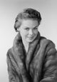 Studio portrait of a young woman wearing a fur coat poster print.