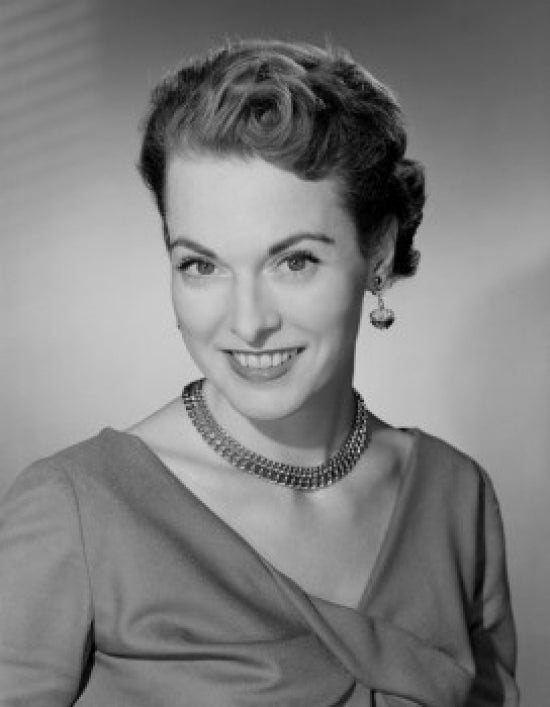 Studio portrait of a mid adult woman smiling poster print.