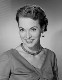 Studio portrait of a mid adult woman smiling poster print.