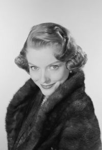 Studio portrait of a young woman smiling, poster print available in multiple sizes.