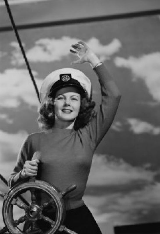 Woman Wearing Sailor Hat at Helm of Ship Poster Print