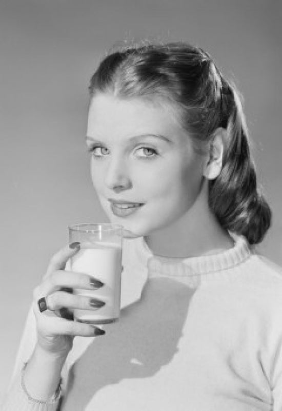 Young woman holding a glass of milk poster print