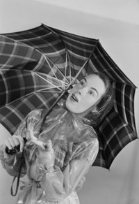 Studio portrait of a young woman holding an umbrella, elegant photography print.