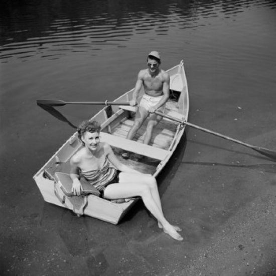 Elevated view of man and woman in fishing boat poster print