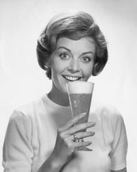 Portrait of young woman enjoying a beer, poster print
