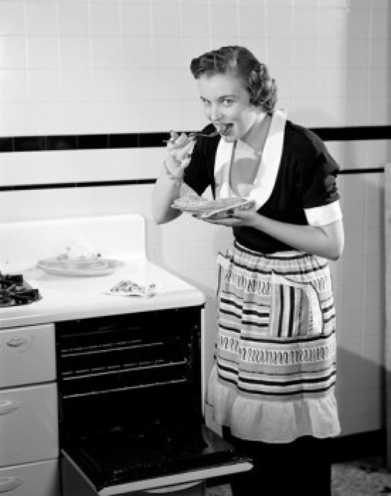 Happy young woman trying freshly baked pie poster print