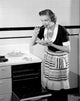 Happy young woman trying freshly baked pie poster print