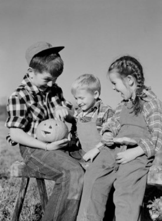 Halloween poster featuring children with a pumpkin, perfect for seasonal decoration.