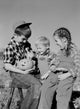Halloween poster featuring children with a pumpkin, perfect for seasonal decoration.