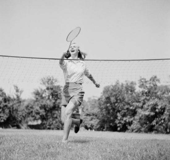 Young woman playing badminton poster print