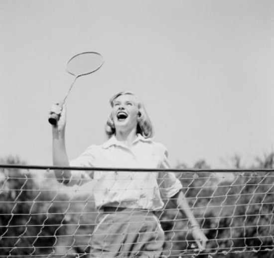 Close-up view of young woman playing badminton poster print.