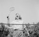 Close-up view of young woman playing badminton poster print.