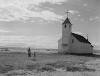 Mother and son in front of a Catholic church in fields poster print.