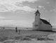 Mother and son in front of a Catholic church in fields poster print.