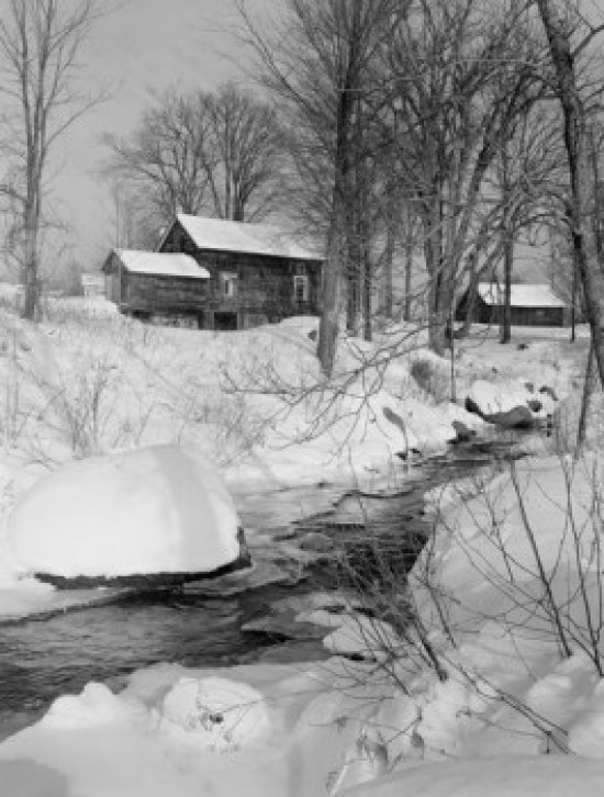 Winter scene in Peterboro, New Hampshire featuring old buildings and a brook.