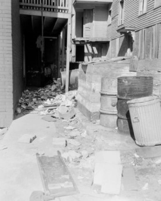 Alley at rear of building with litter poster print showcasing urban life in Worcester, Massachusetts.