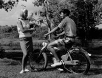 Teenage boy on motorbike talking to a teenage girl poster print.