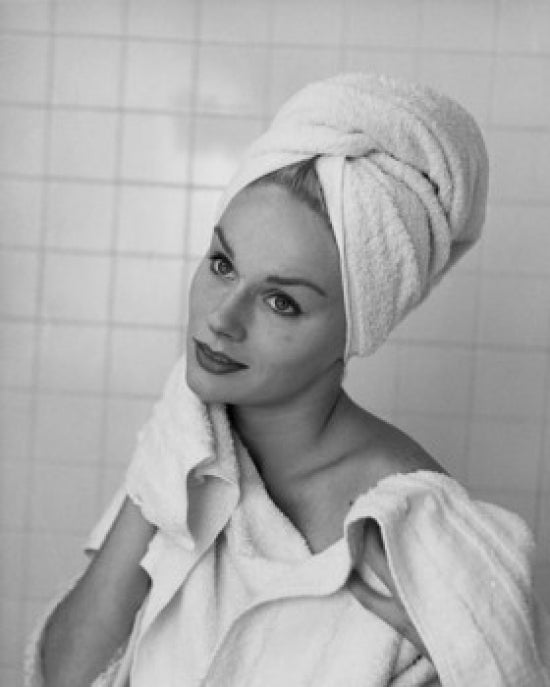 Close-up poster print of a young woman drying her neck with a towel.