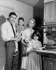 Portrait of parents and children standing in a kitchen poster print.